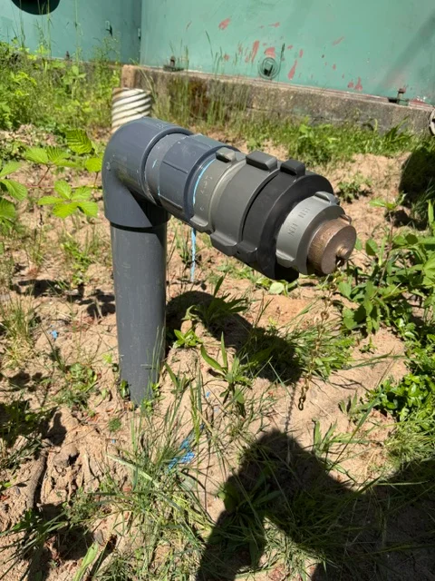 PVC irrigation valve assembly with multiple compression fittings installed in residential landscape