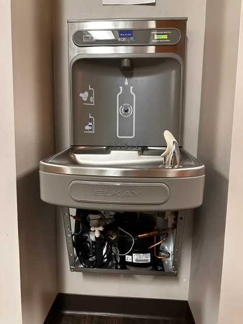 Stainless steel Elkay water fountain with bottle fill station mounted in wall
